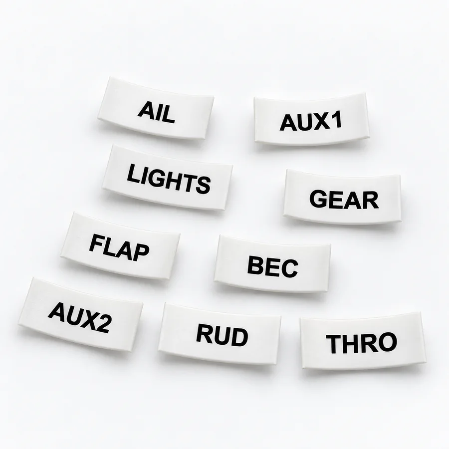 Assorted white heat-shrink servo lead labels printed AIL, ELE, RUD, THRO, FLAP, GEAR, AUX1, AUX2, BEC and LIGHTS