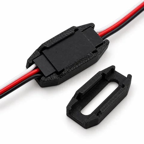 A black safety lock fitted around a joined servo connection